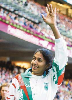 Anju Bobby George waves after displaying the bronze medal she won