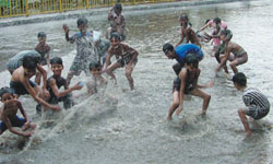 Children in the Adarsh Nagar area having a good time after rain lashed the Capital on Saturday. 