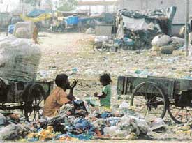 A cluster of shanties in a public park along the GT Road, near sabzi mandi