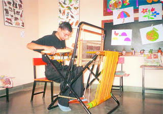 Twentyfive-year-old mentally challenged and visually impaired Ajay Joshi works on a loom