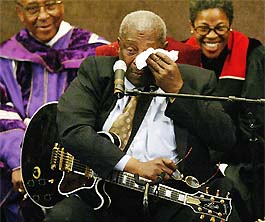 Blues artiste B.B. King wipes his tears while performing during the funeral of legendary musician Ray Charles in Los Angeles