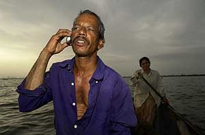 A fisherman uses a mobile phone while still at sea near Kochi.