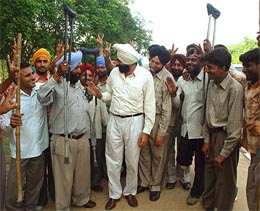 General secretary of Punjab Pradesh Congress Committee Parminder Singh celebrates with handicapped Punjab Government employees in Chandigarh on Monday. 