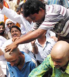 Vishwa Hindu Parishad activists tonsure their heads in protest against J&K Governments decision to restrict the Amarnath pilgrimage for one month