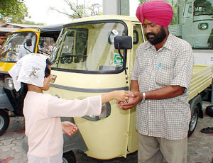 Surjit Singh, father of three muscular dystrophy- ridden girls from Takhtu Majra village, Rajpura, receives keys of a Piaggio diesel three-wheeler from a girl child