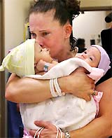 Melissa Buckles, of Woodbridge, Va, weeps as she prepares to hand off her conjoined twin daughters Jade and Erin Buckles for their surgery at Childrens National Medical Center in Washington