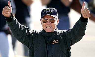 Pilot Mike Melville flashes thumbs up signs following his historic flight at the Mojave Airport in California on Monday