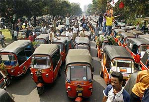 Drivers park their three-wheeled motorised taxis called "Bajaj" outside the city hall during a protest in Jakarta