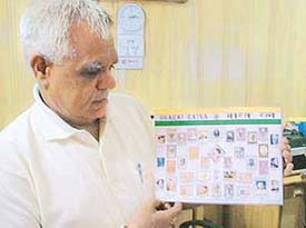 Mr Yash Pal Bangia shows one of his prized collection of stamps in Ludhiana.
