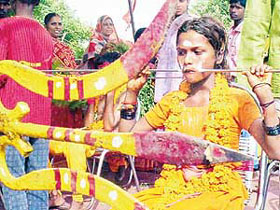 A Tamil devotee pierces a nine-foot-long trident through her mouth during their "Shitla Mata Utsav" in Patiala on Wednesday.