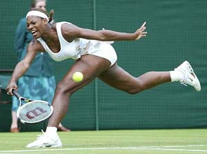 Defending champion Serena Williams reaches for a shot from China's Jie Zheng, during their first round match at Wimbledon on Tuesday