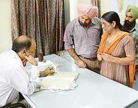 Mohali SDM M.L. Sharma checks the attendance register during a raid at the Government ITI