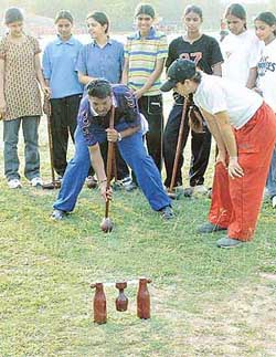 Chief referee Rajesh Paspulkar gives tips to youngsters in wood ball at the Panjab University ground in Chandigarh