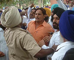 Policemen pacify Shiromani Akali Dal and Panthic Morcha supporters outside the SDMs office in Tarn Taran on Thursday. 
