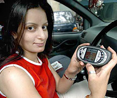 Public relations representative Rowena shows a new Nokia N-Gage QD game deck mobile telephone handset as she plays a game in her car in New Delhi on Friday. Nokia N-Gage QD handset has 3.4 MB internal user memory,16 MB SD ram, Blue Tooth and a HTML browser. 