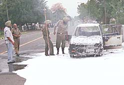 The police inspects the car that caught fire near the Haryana Chief Ministers residence in Chandigarh on Friday.
