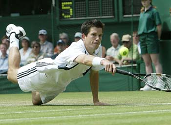 Britain's Tim Henman dives in an attempt to reach a shot from Switzerland's Ivo Heuberger during the men's singles second-round match