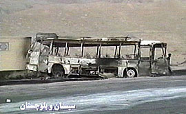 A TV grab taken on Friday shows a burnt bus at the scene of a fuel truck accident outside Zahedan.. At least 90 persons died on Thursday when a fuel truck lost control and crashed in to a police post.