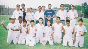 Members of the Satluj Coaching Centre cricket team with their trophies