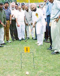The Punjab Finance Minister, Mr Lal Singh, takes a stroke during the opening ceremony of the National Gateball Championship at Panjab University