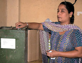 A woman casts her vote at Khyala in the Capital