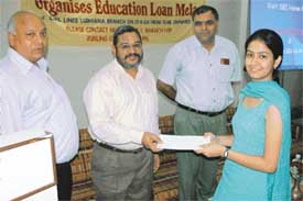 A student receives sanction letter during an education loan mela organised by the State Bank of India in Ludhiana 