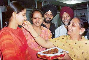 Class X examination (Punjab School Education Board) Patiala topper Gaganpreet Kaur being congratulated by her school Principal, Ms Jaswinder Kaur Dardi