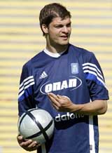 Greek striker Angelos Haristeas chats with teammates during a training session in Lisbon 