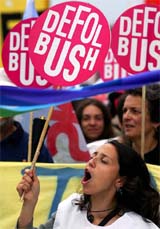 A Turkish demonstrator chants slogans as she holds a placard that reads, Get out Bush, during a protest just hours before US President George W. Bush's arrival