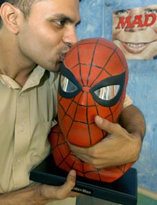 Mr Jeevan J. Kang, studio chief of Gotham Studios, poses with a bust of comic book hero Spiderman at the Gotham Entertainment Group office in Bangalore 
