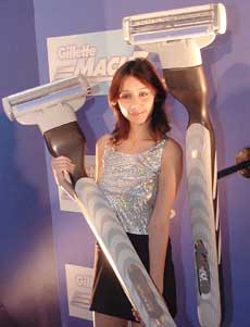 A model displays a model of Gillettes Mach3Turbo during its launch in New Delhi 