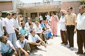 Retrenched employees of the ESPL outside the factory before it was reopened in Mohali