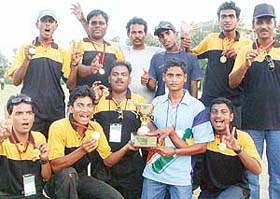 The victorious Orissa team with the trophy which they won beating Haryana