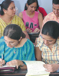 Students giving finishing touches to their admission forms at Hindu College in the Capital on Monday.