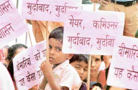 A child carries a placard during a BJP dharna against the MC in Ludhiana