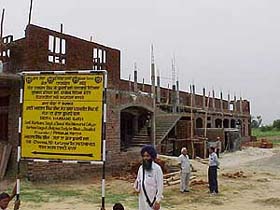 Mr Avtar Singh Cheema, an NRI, is seen in front of the building of Dera Harbansgarh Dharmik Vidya Kendra, which is coming up at Kartarpur in Jalandhar