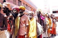 Amarnath-bound sadhus stand in a queue for yatra registration at Jammu