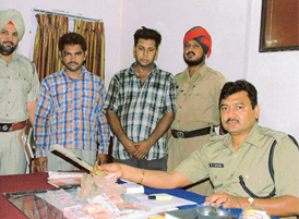 Policemen with the two suspected robbers arrested in Ludhiana