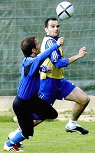Greece's Demis Nikolaidis challenges teammate Michalis Kapsis for the ball during a training session 