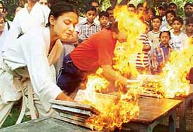 Girls break firebricks at the concluding ceremony of "self-defence sports training camp", organised by the All-India Anti-terrorist Front in Chandigarh