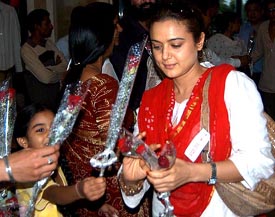 Bollywood actress Preity Zinta accepts bouquets from her fans at a hotel in Amritsar