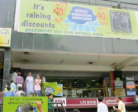 Banners proclaim heavy discounts during monsoon sales