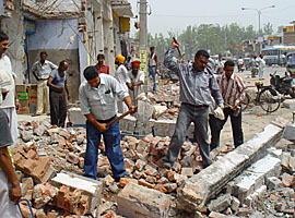 Following court orders, shopkeepers remove structures from government land along the Chandigarh-Ambala Highway in Zirakpur