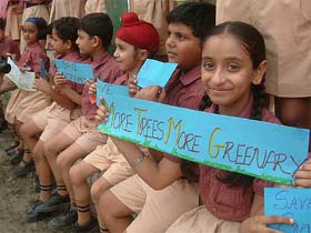 Students of Ryan International School hold placards to spread the message of environment preservation
