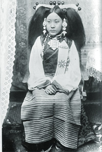 Portrait of an aristocratic woman of Lhasa wearing typical Central Tibetan coral and pearl headdress