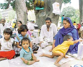 Vinod with his wife, Santosh, and four children under the huge mango tree at the PGI in Chandigarh