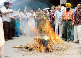 Residents of Dholewal Chowk burn a rag doll to appease the raingods just hours before the downpour in Ludhiana