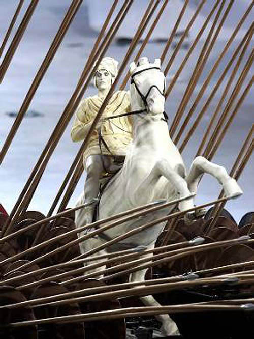 An actor portraying Alexander the Great performs during the opening