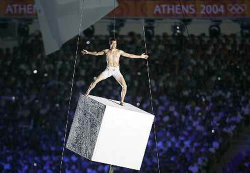 An artist performs on a cube, which symbolises the Earth, during the opening ceremony of the Athens 2004 Olympic Games.  Photo by Reuters