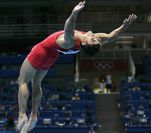 Romania's Ioan Silviu Suciu performs a floor exercise during the men's artistic gymnastics qualifying session at the Athens 2004 Olympic Games August 14, 2004. REUTERS/Jeff J Mitchell